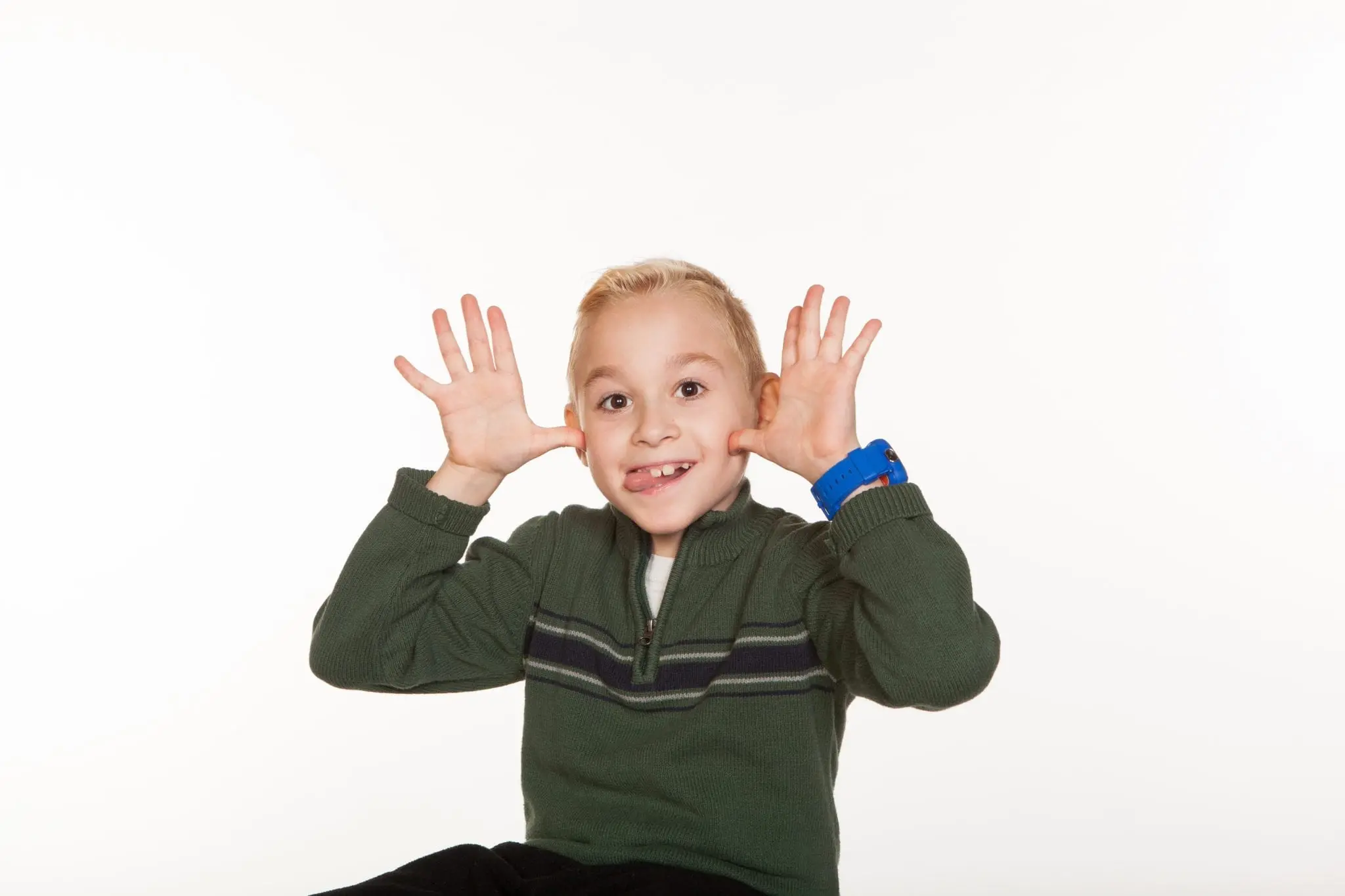 Blonde boy making a funny face and smiling playfully after recovery