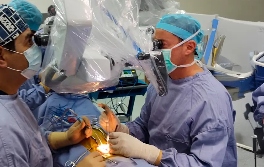Dr. Amir Kershenovich performing delicate brain surgery using a surgical microscope