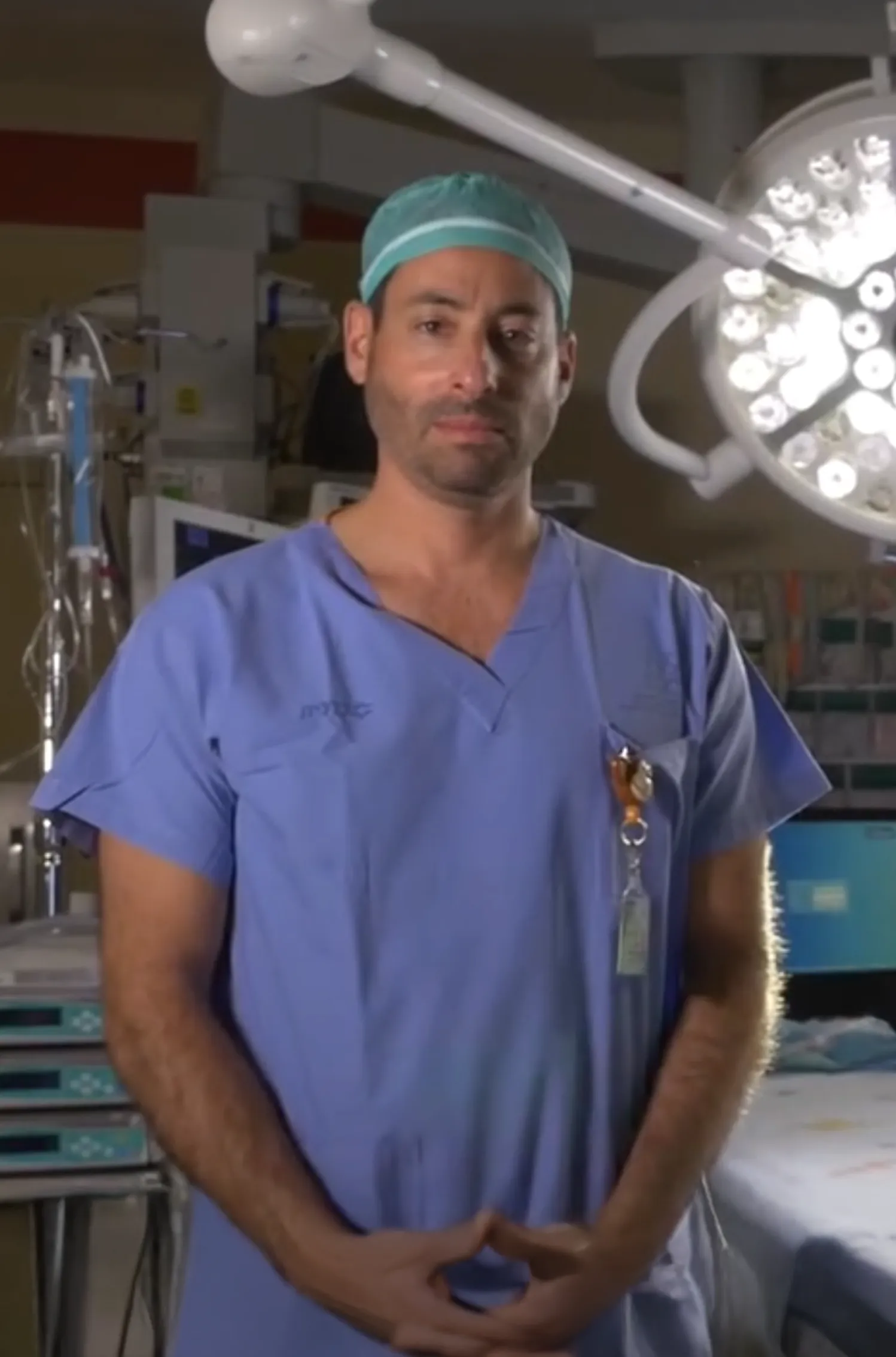 Pediatric neurosurgeon Dr. Amir Kershenovich sitting with a recovering child